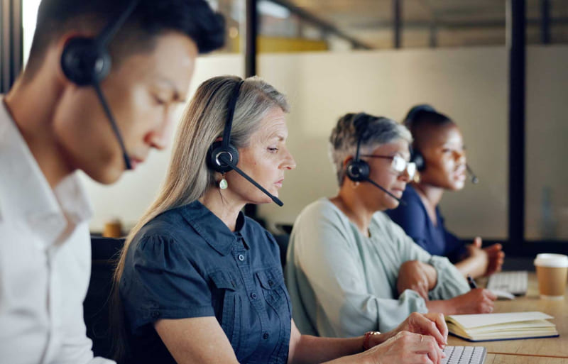 People sitting at a desk with headphones