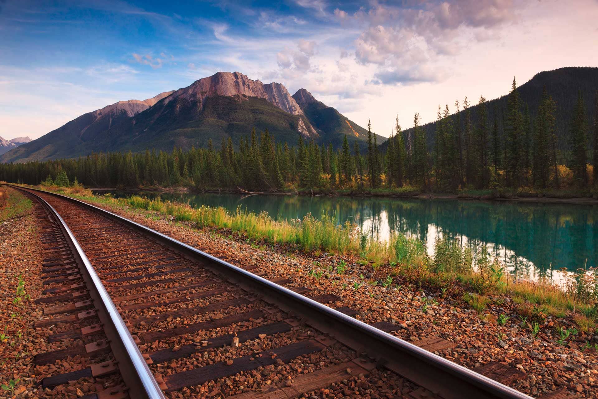 Train tracks next to a scenic mountain view