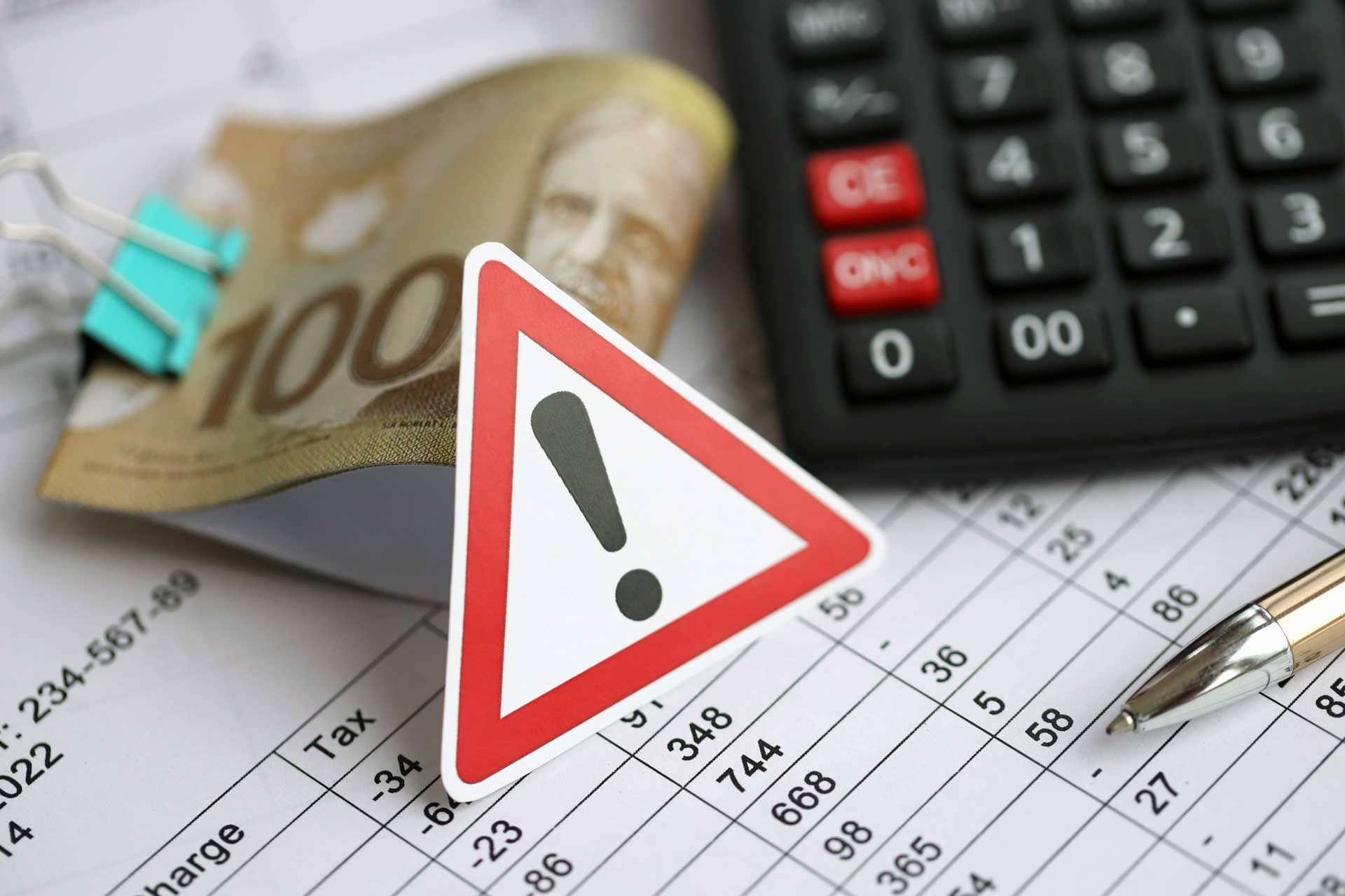 Alert icon next to money and a calculator